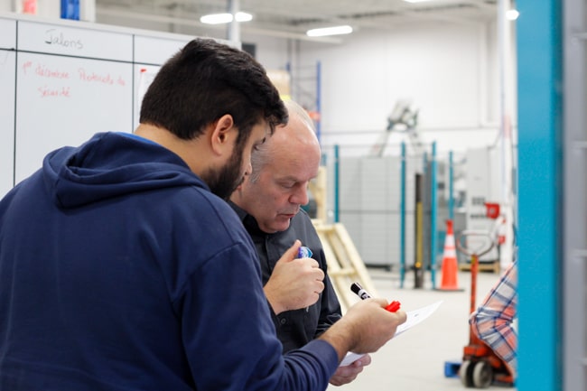 NūMove employees in a robot workshop