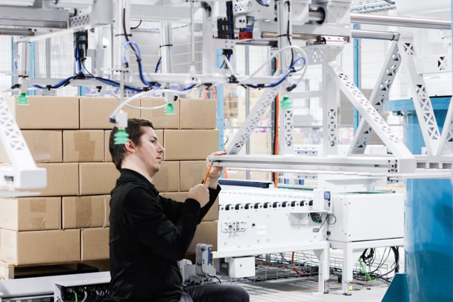 NūMove's employee working on a robot