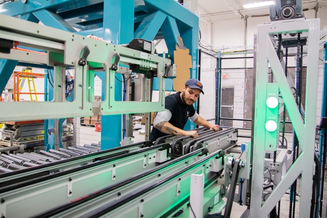 NūMove's employee installing a conveyor belt
