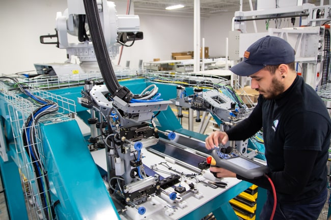 NūMove employees working on a robot