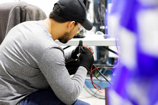 NūMove's employee testing electrical wiring