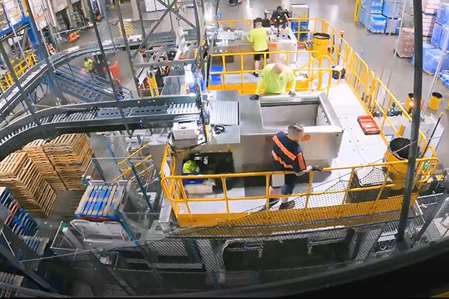 operators on a mezzanine performing the manual mixed palletizing